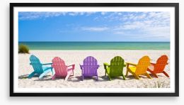 Rainbow chairs on a sunny beach Framed Art Print 65357803