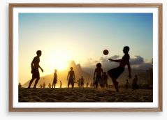 Beach football at sunset
